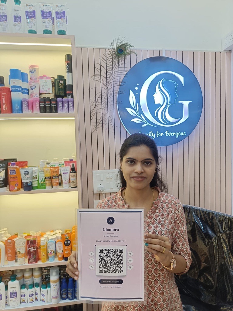 Glamora Unisex Cosmetics staff holding a ReviewLoop QR flyer in the store