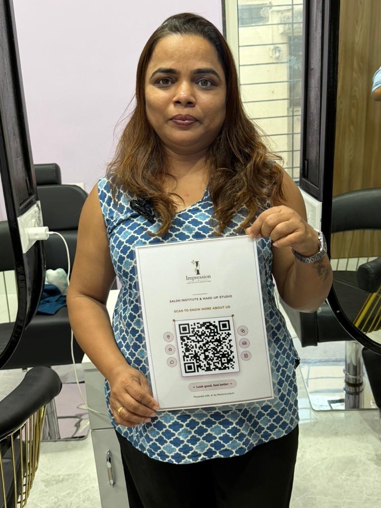 Impression Salon Institute staff holding a ReviewLoop QR sign in the institute