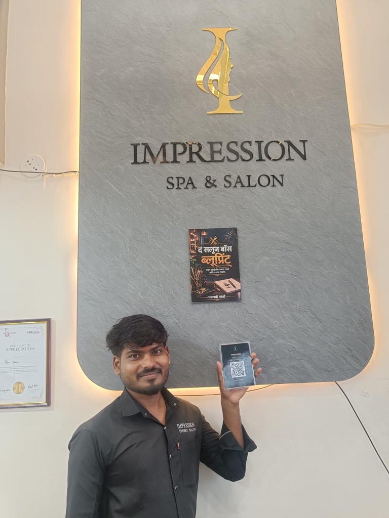 Impression Spa staff with a ReviewLoop QR standee at reception